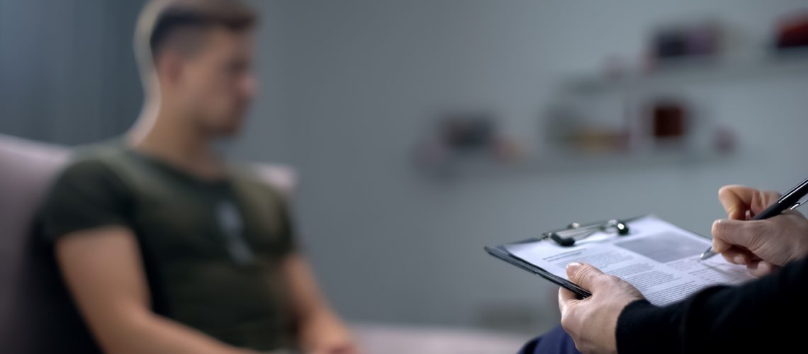 Military soldier discussing sexual abuse case with attorney.