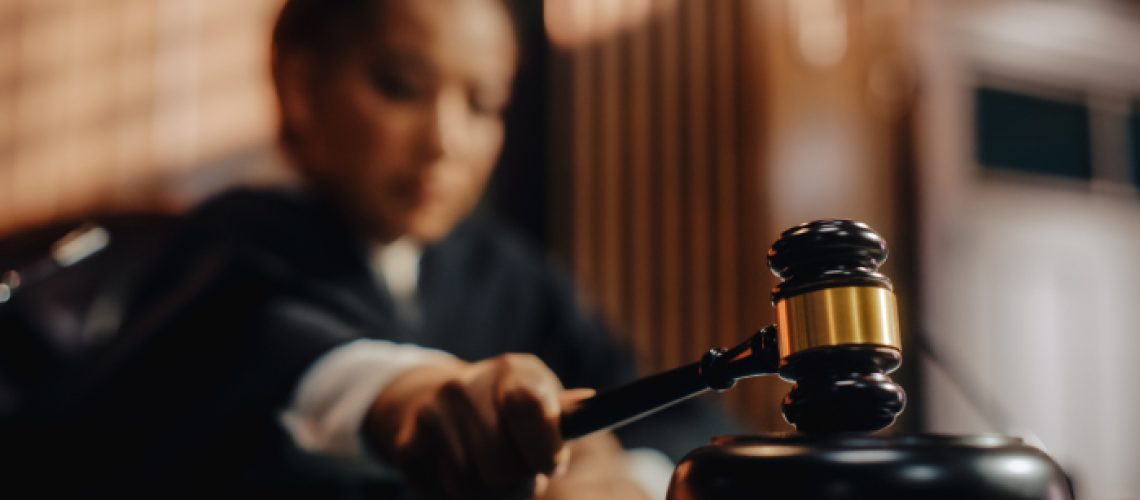 A judge hits her gavel in the court