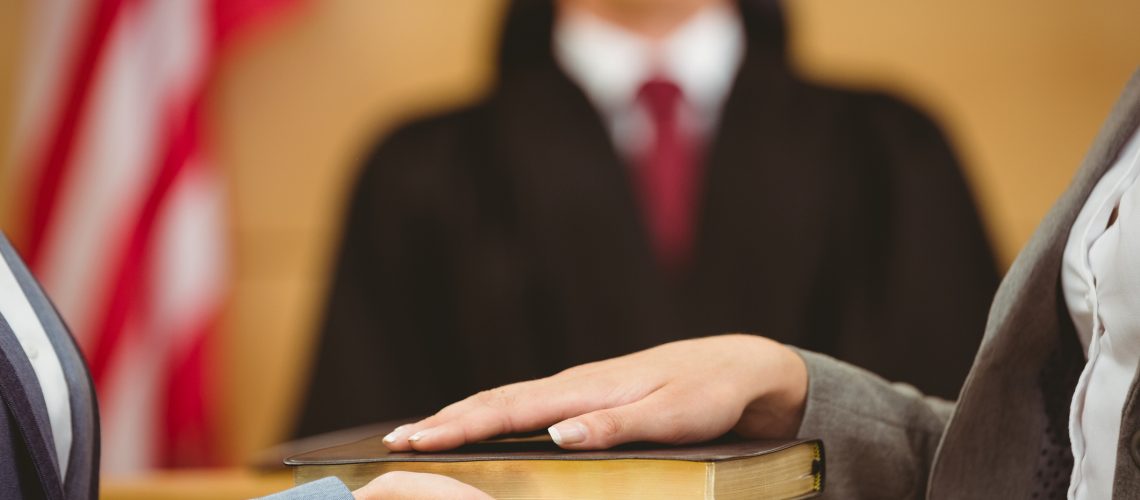Expert witness being sworn in at a court martial court.