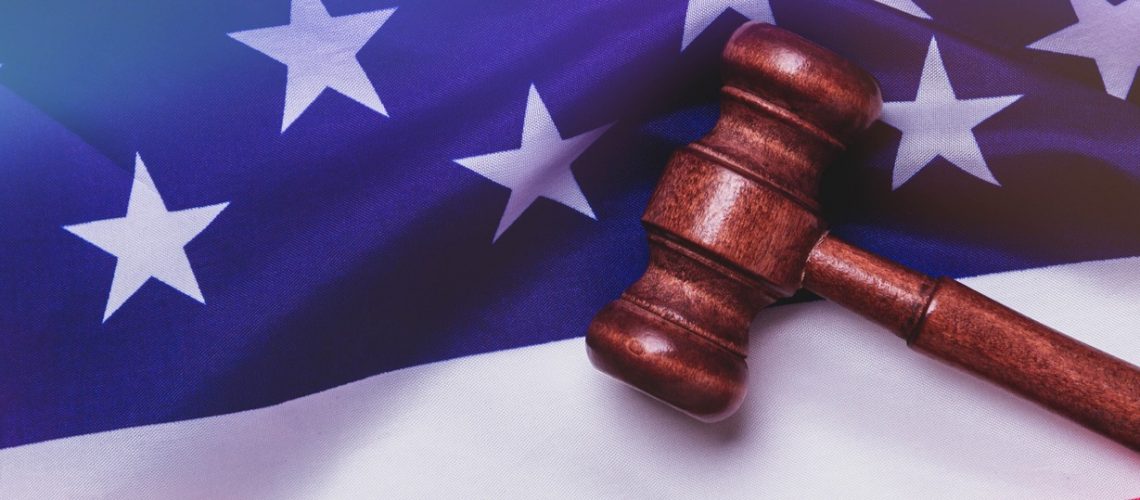 A gavel laying across an American flag