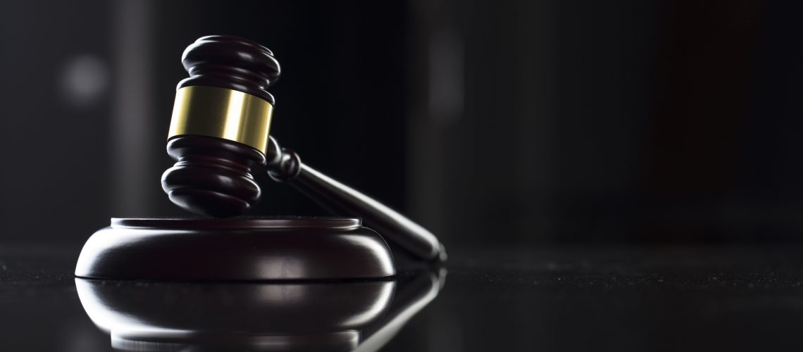 Gavel - law symbol on black background.