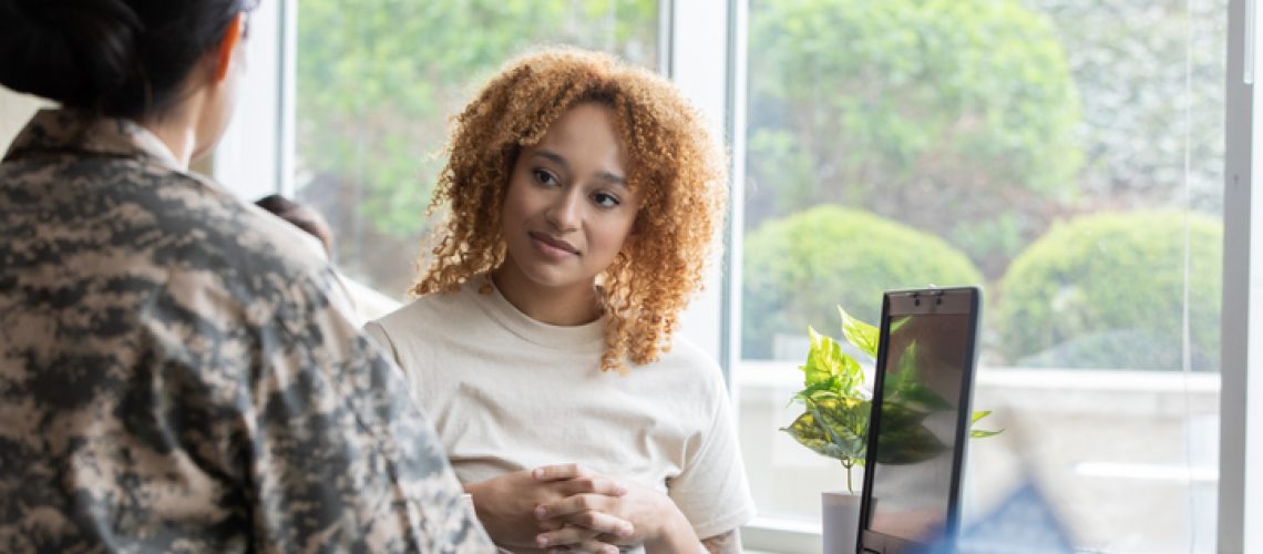 Military service member discussing debt with financial advisor