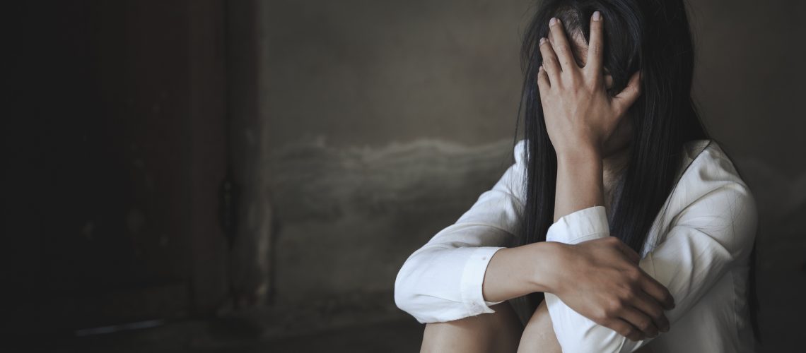 Women sitting on the floor crying with depression, Depressed woman, family problems, Stress, kitchen, abuse, Domestic violence, The concept of depression and suicide.