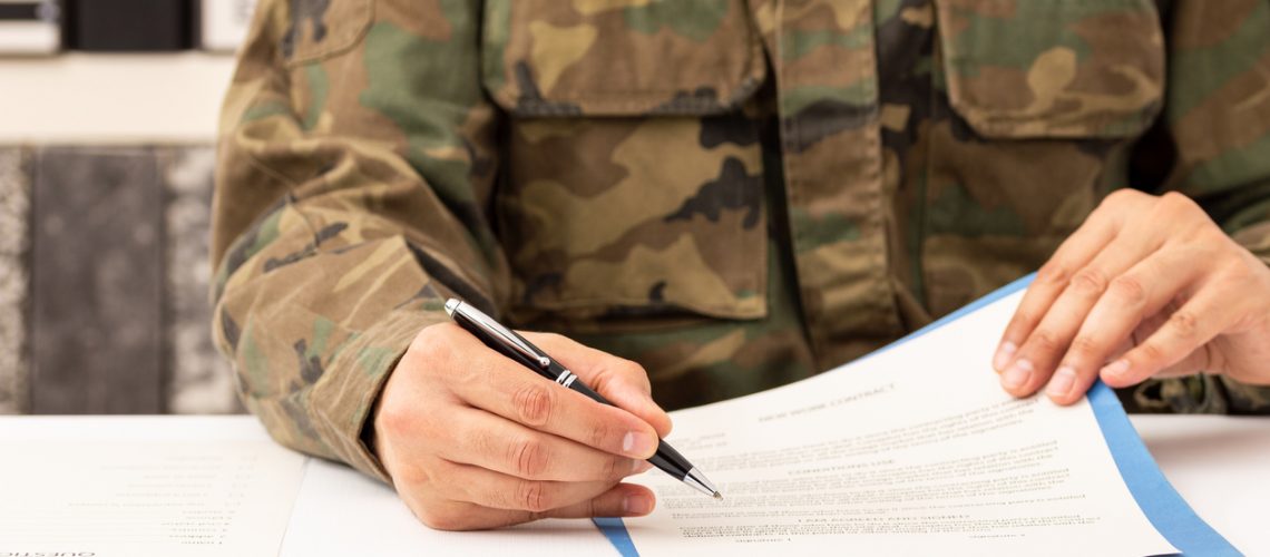 Military soldier filling out disability documents