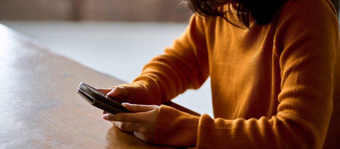 depressed woman looking at phone